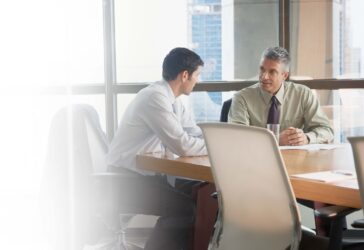 two-men-talking-in-conference-room